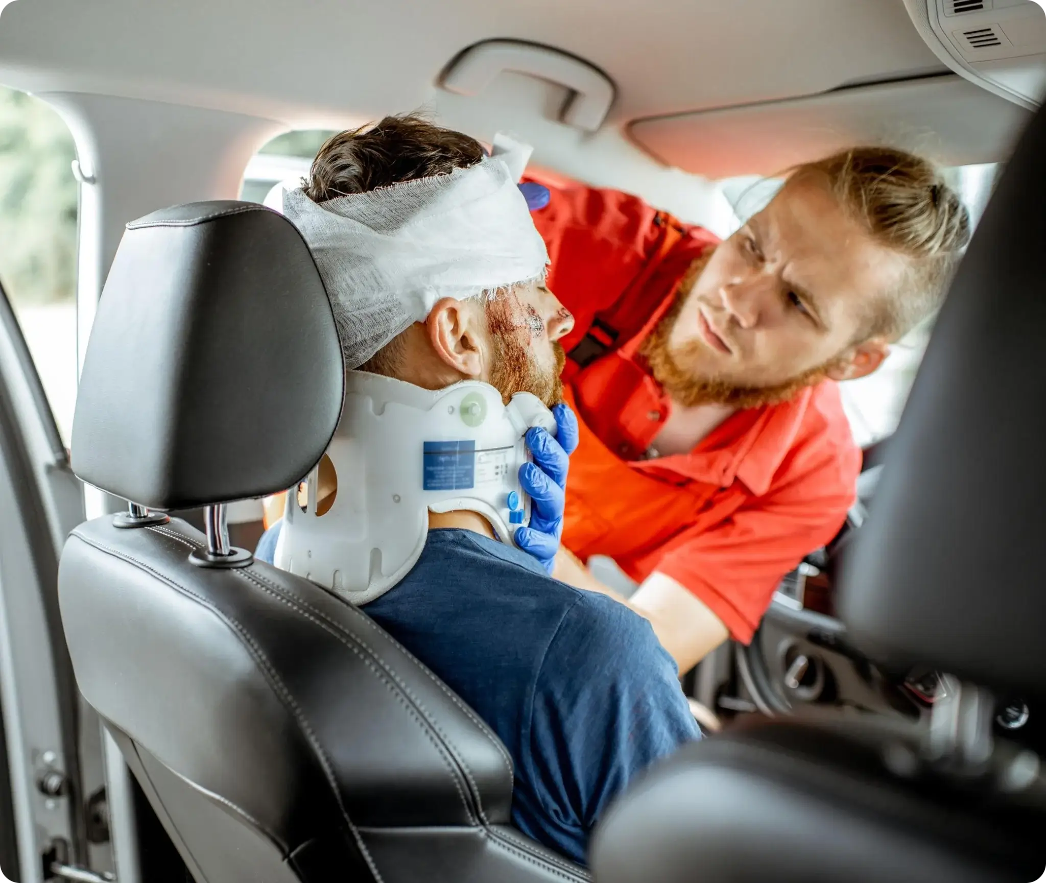 A medical professional providing emergency neck and head injury assistance to a car accident victim.