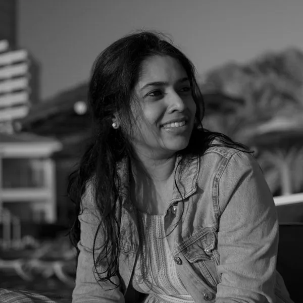 Woman with long dark hair smiling in casual shirt at Novare Injury Care Fort Myers.