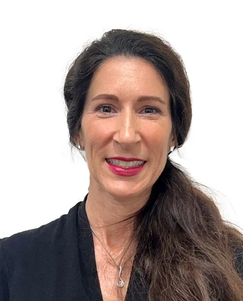 Professional female healthcare provider smiling in dark blazer from Fort Myers Novare Injury Care.