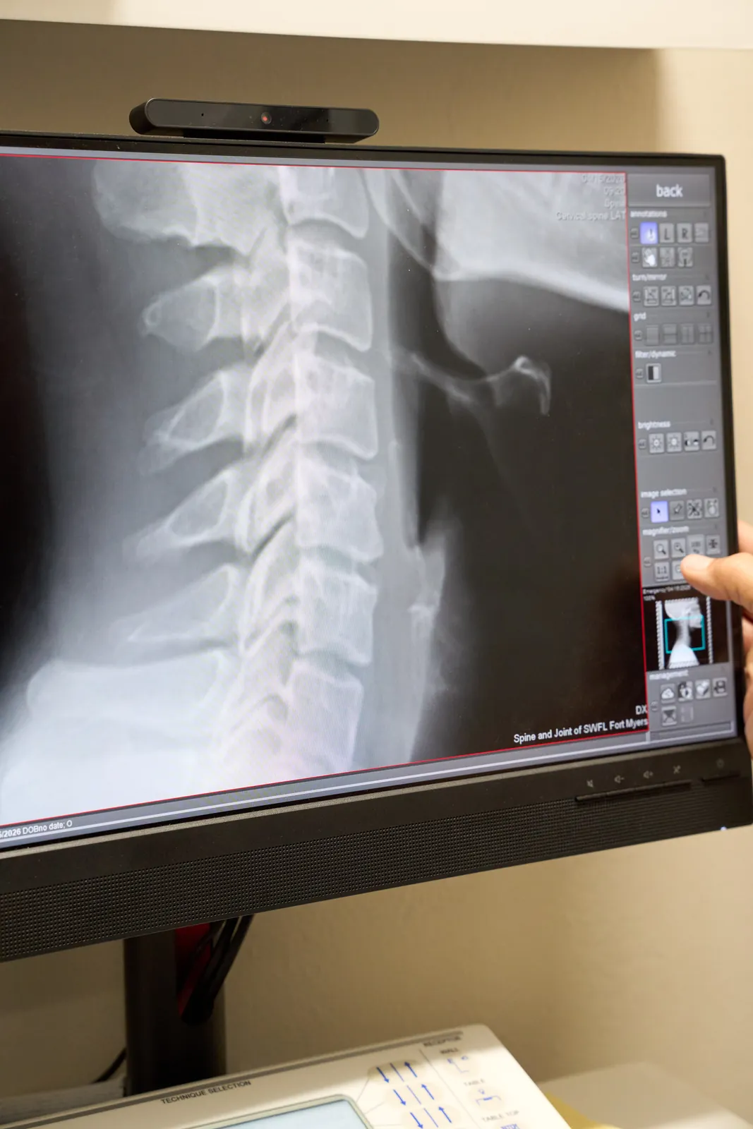 Dr. Ivan performing chiropractic evaluation at Novar&eacute; Injury Care